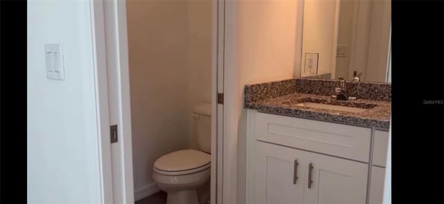 bathroom featuring toilet and vanity