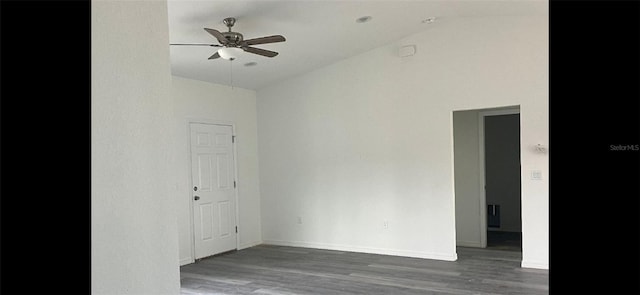 spare room with baseboards, a ceiling fan, vaulted ceiling, and wood finished floors