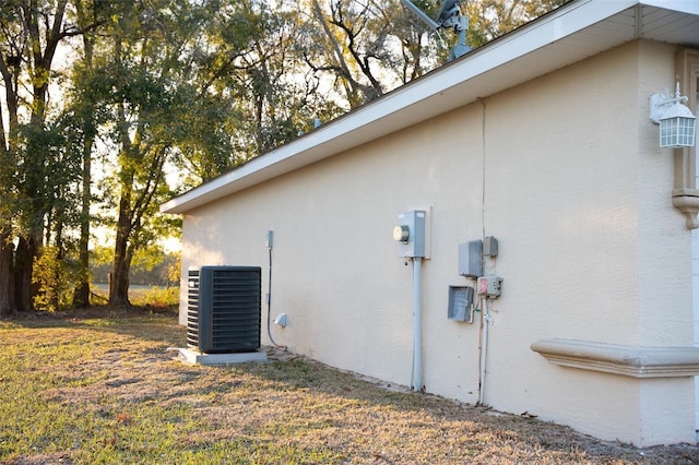 view of home's exterior with central AC unit and stucco siding