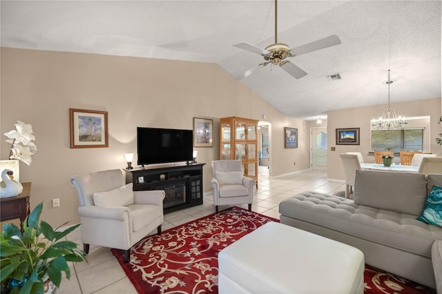 living area featuring light tile patterned flooring, vaulted ceiling, visible vents, and ceiling fan with notable chandelier