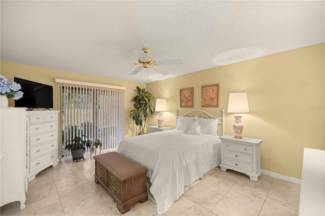 bedroom featuring baseboards, a ceiling fan, marble finish floor, access to outside, and a textured ceiling