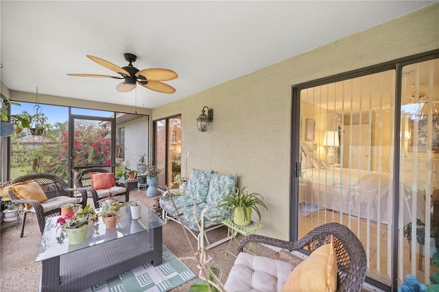 sunroom / solarium featuring a ceiling fan