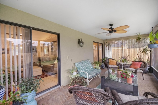 sunroom / solarium featuring ceiling fan