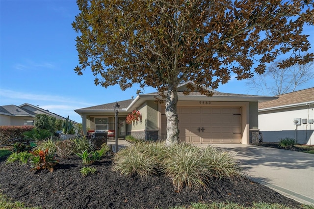 view of front of home with a garage, driveway, and stucco siding