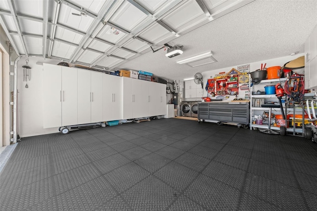 garage with a garage door opener and washer and clothes dryer