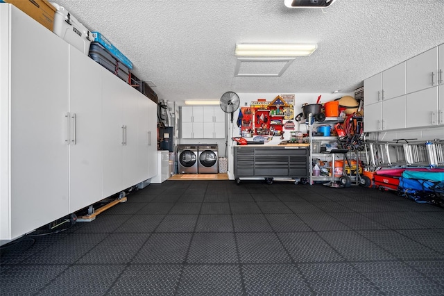 garage featuring washer and dryer and a workshop area