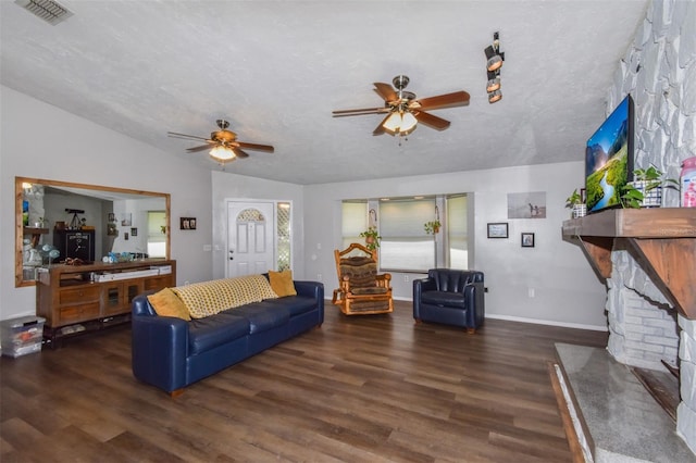 living area with lofted ceiling, visible vents, a textured ceiling, and wood finished floors