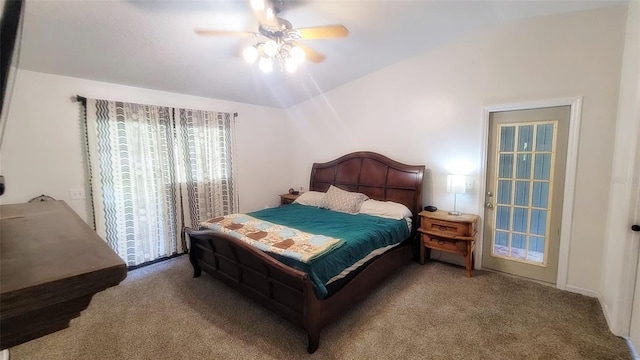 bedroom featuring lofted ceiling, carpet, and a ceiling fan