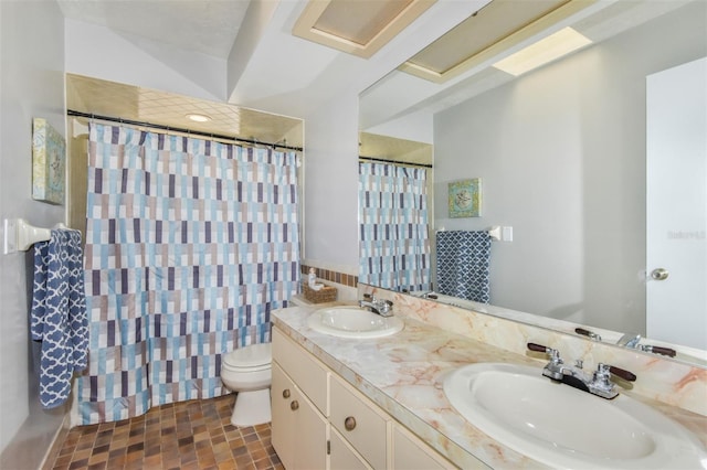 bathroom with curtained shower, a sink, toilet, and double vanity