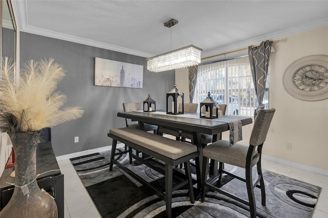 dining room with baseboards, ornamental molding, and a notable chandelier