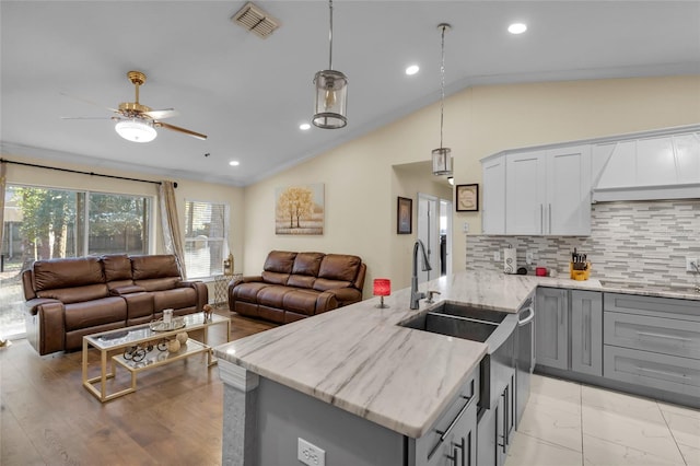 kitchen with open floor plan, gray cabinets, and lofted ceiling