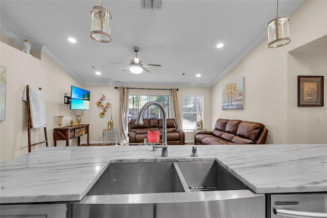 kitchen with light stone counters, visible vents, open floor plan, and a sink