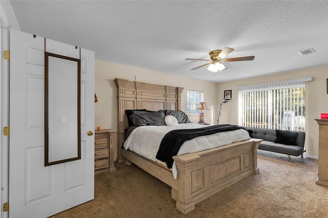 bedroom with light carpet, visible vents, and a textured ceiling