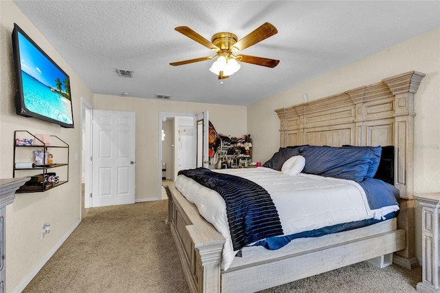 bedroom featuring ceiling fan, visible vents, a textured ceiling, and light colored carpet