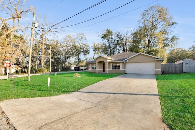 view of front of home with stucco siding, a front yard, fence, a garage, and driveway