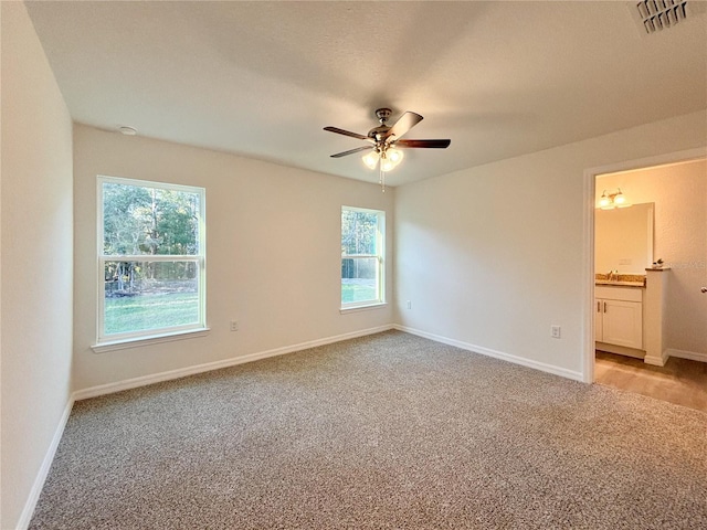 unfurnished bedroom featuring baseboards, visible vents, and light colored carpet