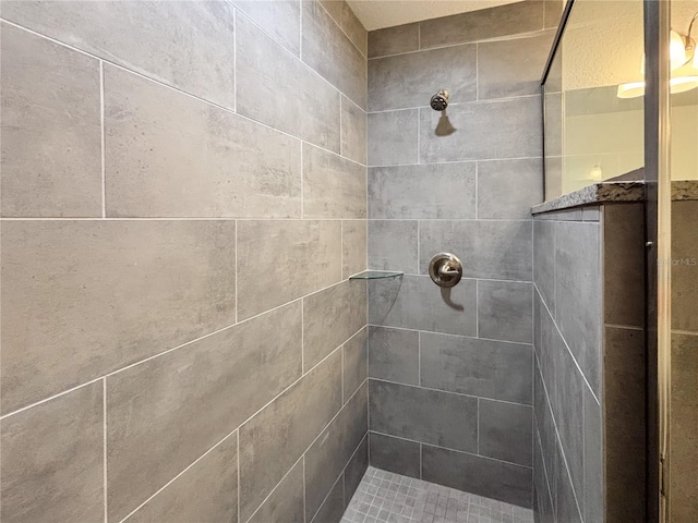 full bath featuring tiled shower