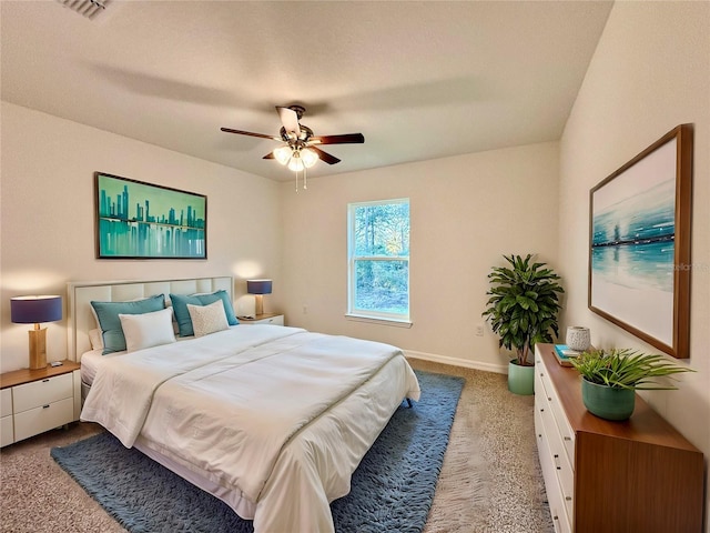 carpeted bedroom featuring baseboards, visible vents, and a ceiling fan