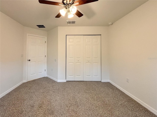 unfurnished bedroom featuring carpet floors, baseboards, and visible vents