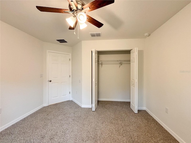 unfurnished bedroom with a closet, visible vents, light carpet, and baseboards