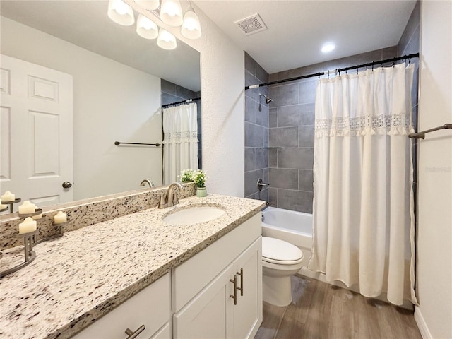 bathroom with shower / tub combo with curtain, visible vents, toilet, vanity, and wood finished floors