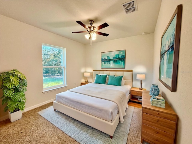 bedroom with carpet floors, visible vents, baseboards, and a ceiling fan