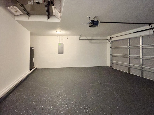 garage featuring electric panel, concrete block wall, and a garage door opener