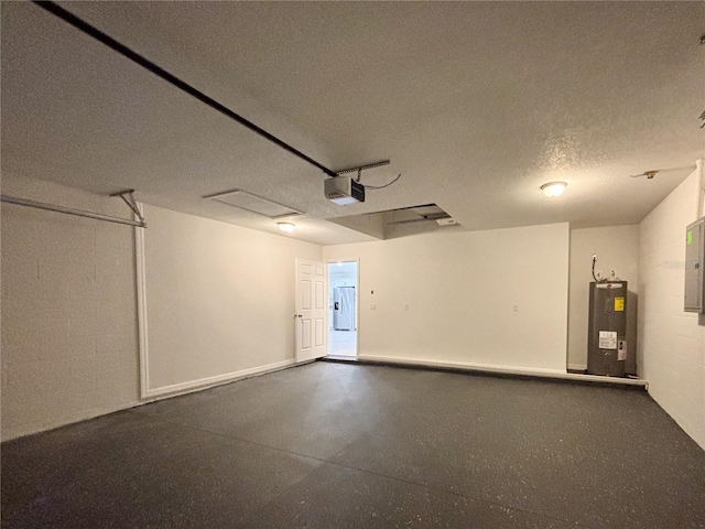 garage with a garage door opener, concrete block wall, electric panel, and electric water heater