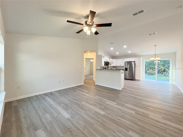 unfurnished living room with lofted ceiling, light wood-type flooring, and visible vents