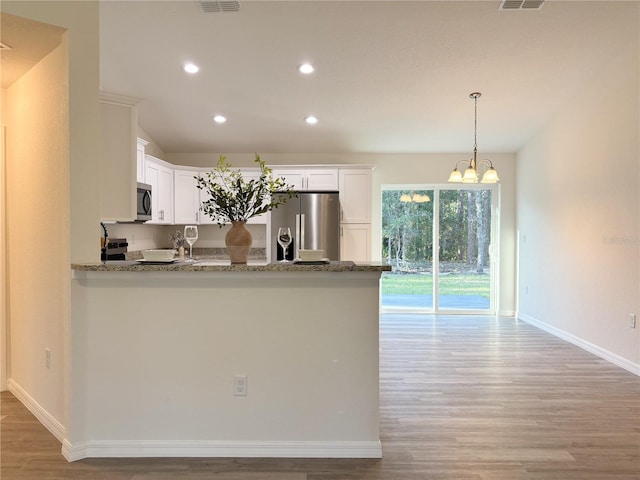 kitchen featuring baseboards, white cabinets, a peninsula, stainless steel appliances, and light wood-type flooring