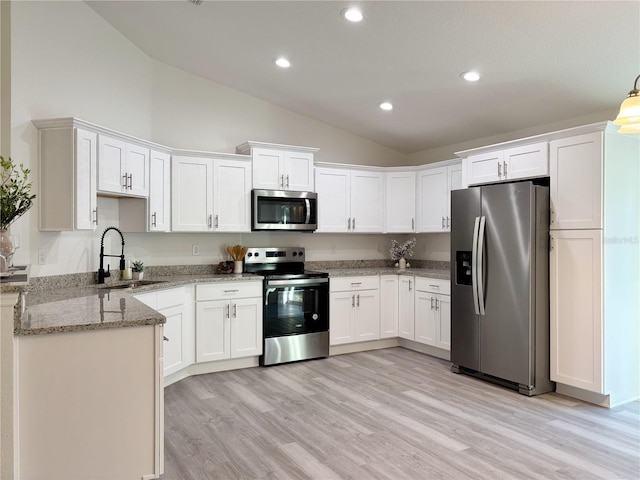 kitchen featuring stainless steel appliances, light wood-style floors, white cabinets, a sink, and light stone countertops