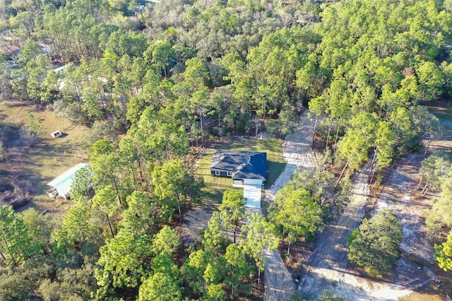 aerial view featuring a wooded view