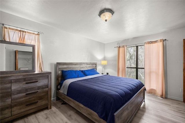 bedroom with wood finished floors and baseboards