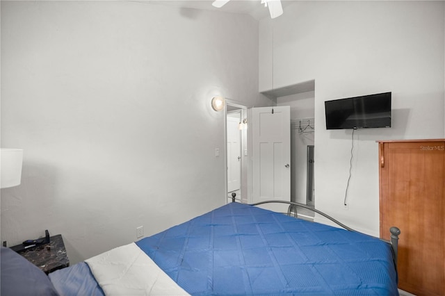 unfurnished bedroom featuring ceiling fan and a towering ceiling