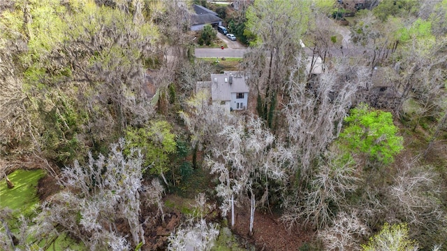 birds eye view of property featuring a view of trees