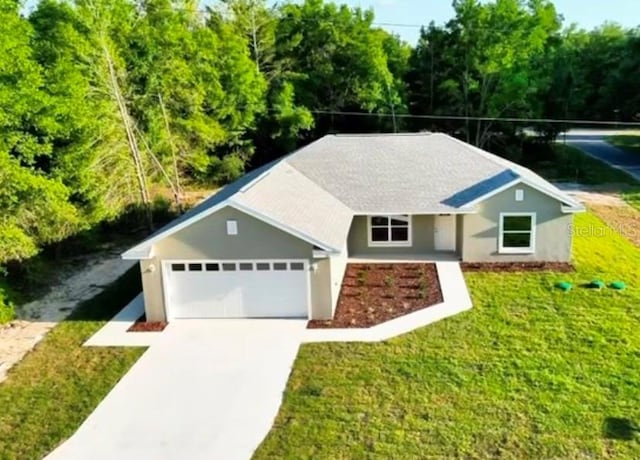 single story home featuring a front yard, driveway, an attached garage, and stucco siding