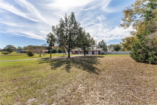 view of front of house with a front yard, fence, and a garage