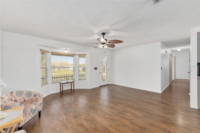 foyer featuring a ceiling fan, dark wood-style floors, baseboards, and a textured ceiling