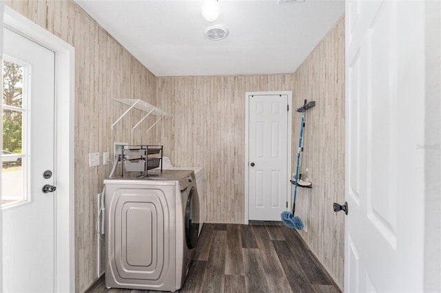 washroom featuring washer and clothes dryer, laundry area, and dark wood-type flooring