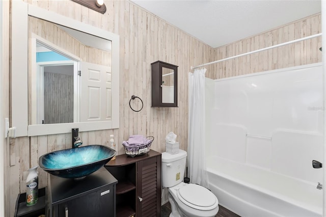 full bathroom featuring vanity, shower / bath combination with curtain, wooden walls, and toilet