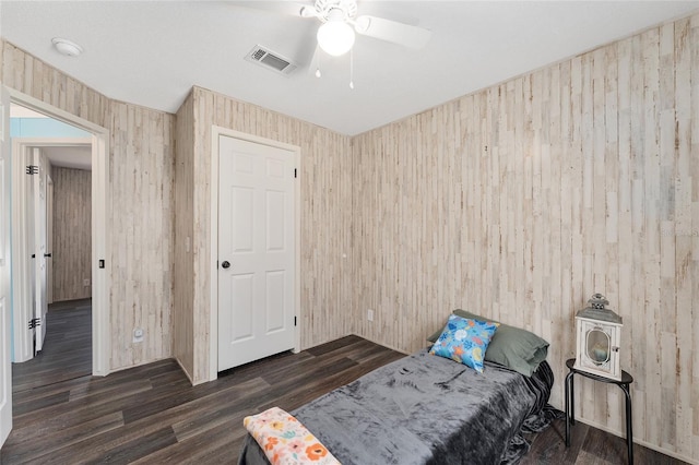 bedroom with wood finished floors, visible vents, and ceiling fan