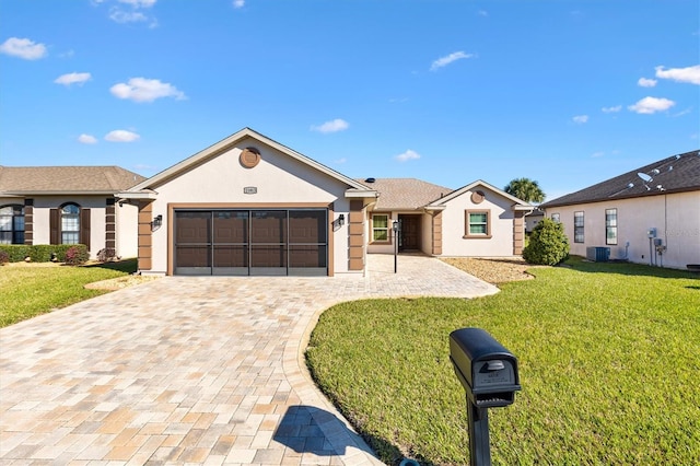 ranch-style house with stucco siding, an attached garage, decorative driveway, central air condition unit, and a front yard