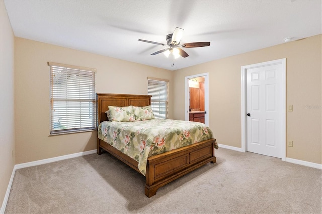 bedroom with light carpet, baseboards, and multiple windows