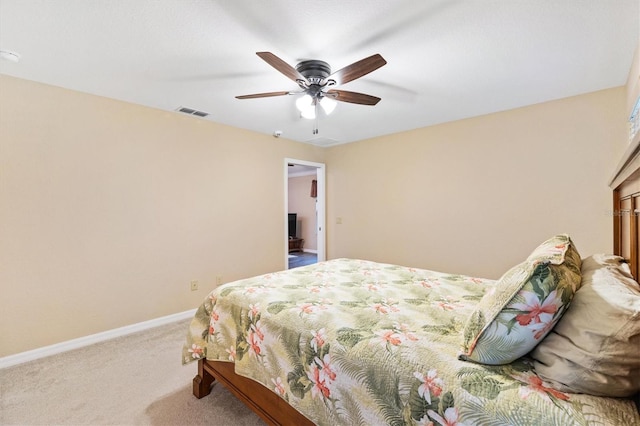 carpeted bedroom with visible vents, ceiling fan, and baseboards