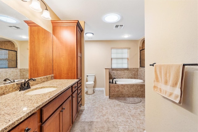 full bathroom featuring a bath, toilet, vanity, and visible vents