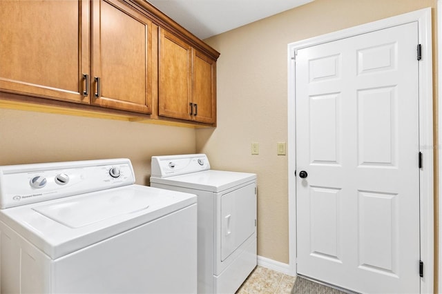 laundry room with cabinet space, washing machine and dryer, and baseboards