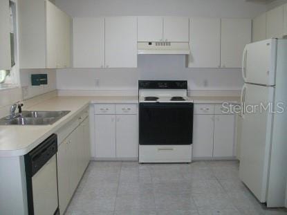 kitchen featuring light countertops, light tile patterned flooring, a sink, white appliances, and under cabinet range hood