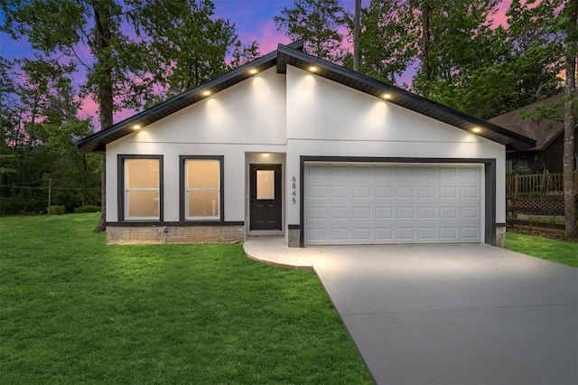 view of front of house with a garage, concrete driveway, a lawn, and stucco siding