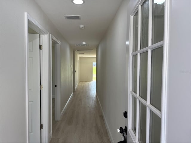 hallway featuring recessed lighting, baseboards, visible vents, and light wood finished floors