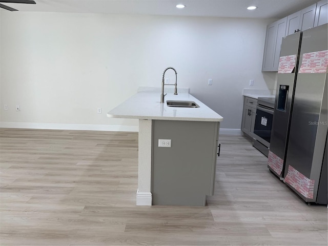 31 Juniper Pass Ln, Ocala, FL 34480 - kitchen featuring stainless steel appliances, a sink, baseboards, light wood finished floors, and recessed lighting